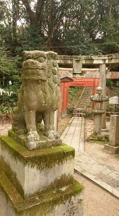 a stone lion statue sitting on top of a cement block