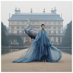 a woman standing in front of a large bird