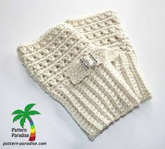 a white knitted sweater with a button on it