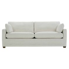 a white couch with two pillows on it