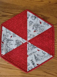 a red and white piece of cloth on top of a wooden table