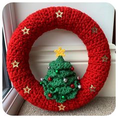 a crocheted christmas wreath with a tree on it