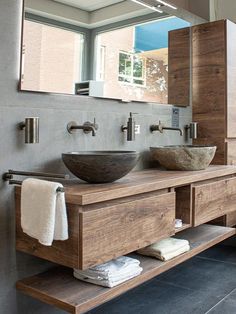 a bathroom with two sinks and a large mirror on the wall next to each other