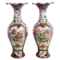 two vases that are sitting side by side on a white surface, each with different designs and colors