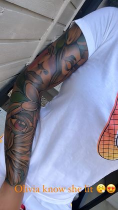 a man with tattoos on his arm and shoulder