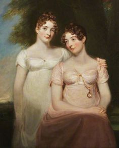 two women in white dresses sitting next to each other