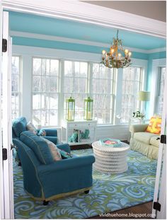 a living room filled with furniture and a chandelier