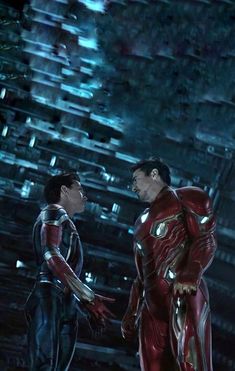 two men in iron man suits standing next to each other with their hands on their hips