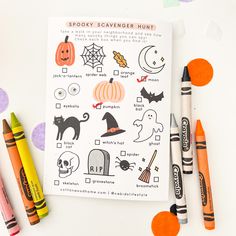 a halloween scavenger hunt with crayons and markers on the table next to it