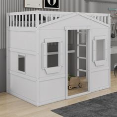 a child's bedroom with a lofted bed and white walls, along with a gray rug on the floor