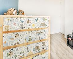 a child's room with toy cars and toys on top of the dressers