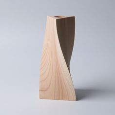 a wooden vase sitting on top of a white table