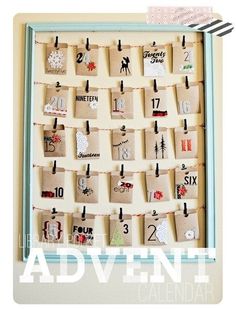 a wooden calendar with clothes pins attached to it