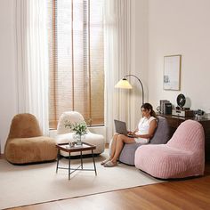 a woman sitting on a couch using a laptop computer