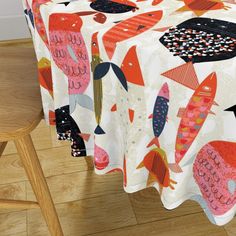 an image of a table cloth with fish on it in the middle of a room