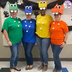 three women wearing silly hats and glasses in front of a bulletin board that says,