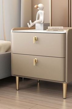 a small white statue sitting on top of a dresser next to a mirror and lamp