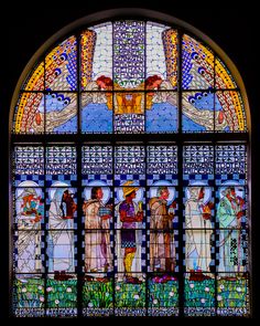 a stained glass window with people in it