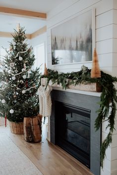 a decorated christmas tree sitting next to a fireplace