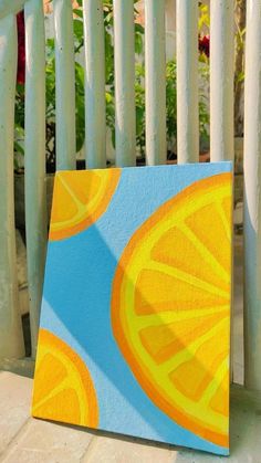 an abstract painting of oranges on a blue and yellow background with white picket fence