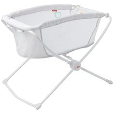 a baby crib that is white and has a handlebar on the bottom side