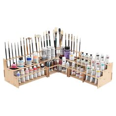 an assortment of paint and acrylic supplies in wooden crates with dividers on each side