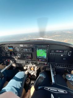 the view from inside an airplane looking down at the cockpit and pilot's feet