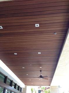 the ceiling is made of wood and has two fans on it