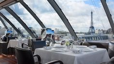 a restaurant with tables and chairs overlooking the eiffel tower