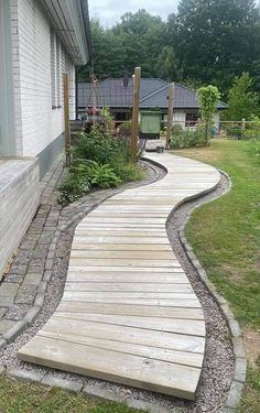 a wooden walkway in front of a house