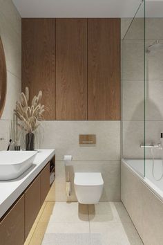 a bathroom with a toilet, sink and bathtub next to a mirror on the wall