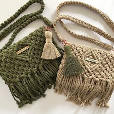 two bags with tassels on them sitting next to each other, one green and the other beige