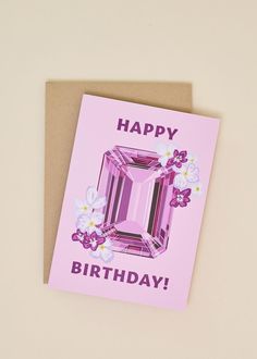 a pink card with an image of a diamond on it that says, happy birthday