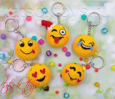 four crocheted smiley face keychains are shown with beads and candy around them