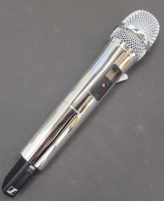 a silver and black microphone sitting on top of a table