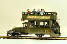 a toy train with people riding on it