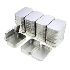 a stack of metal pans sitting next to each other on top of a white surface