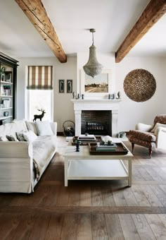 a living room filled with furniture and a fire place in the middle of a room