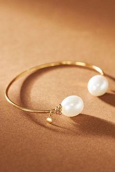 A delicate addition dotted with pearls on both sides, this slim gold-tone cuff is a subtle statement of refined elegance. Elegant Pearl Drop Bangle Bracelet, Gold Pearl Bangle Cuff Bracelet, Elegant Pearl Cuff Bracelet For Formal Occasions, Chic Gold Pearl Bracelet For Wedding, Elegant Gold Pearl Bangle, Pearl Cuff Bracelet, Pearl Cuff, Vintage Inspired Jewelry, Bride Accessories