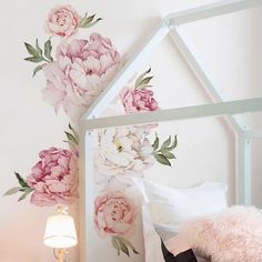 a bedroom with pink flowers painted on the wall