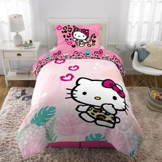 a hello kitty bed set with pink and green accents