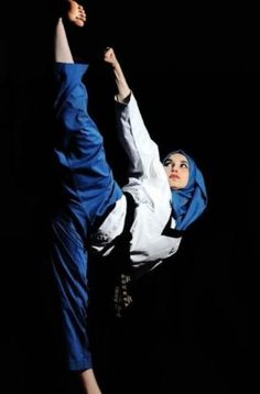 a woman in blue and white doing a handstand