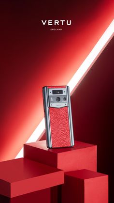 a cell phone sitting on top of a red box with the words vertu