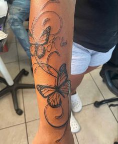 a woman's arm with a butterfly tattoo on it