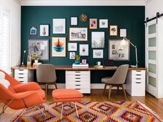 a home office with green walls and pictures on the wall, including an orange chair