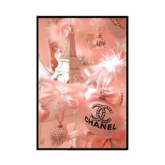 a chanel ornament hanging from the side of a christmas tree with pink feathers