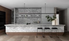 a kitchen with marble counter tops and bar stools