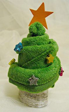 a green christmas tree made out of yarn with a star on top and other decorations around it