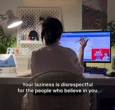 a woman sitting in front of a computer screen with the words your lazines is disrespectful for the people who believe in you