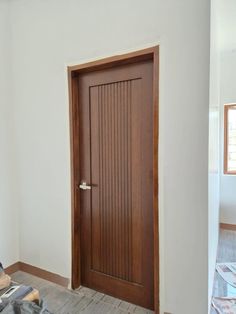 an empty room with a wooden door in it